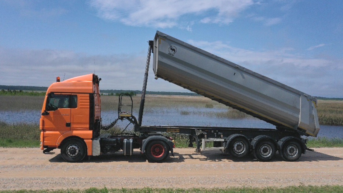 Orange MAN truck near the lake